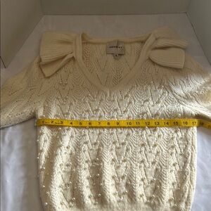 Cream V-Neck Sweater with Chevron Knit and Bow Accents
